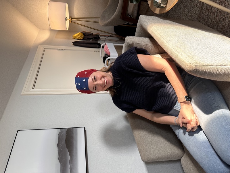 Smiling woman wearing EEG cap during neurofeedback session